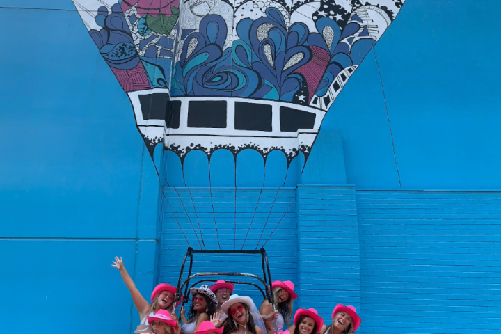 a group of people standing in front of a boat