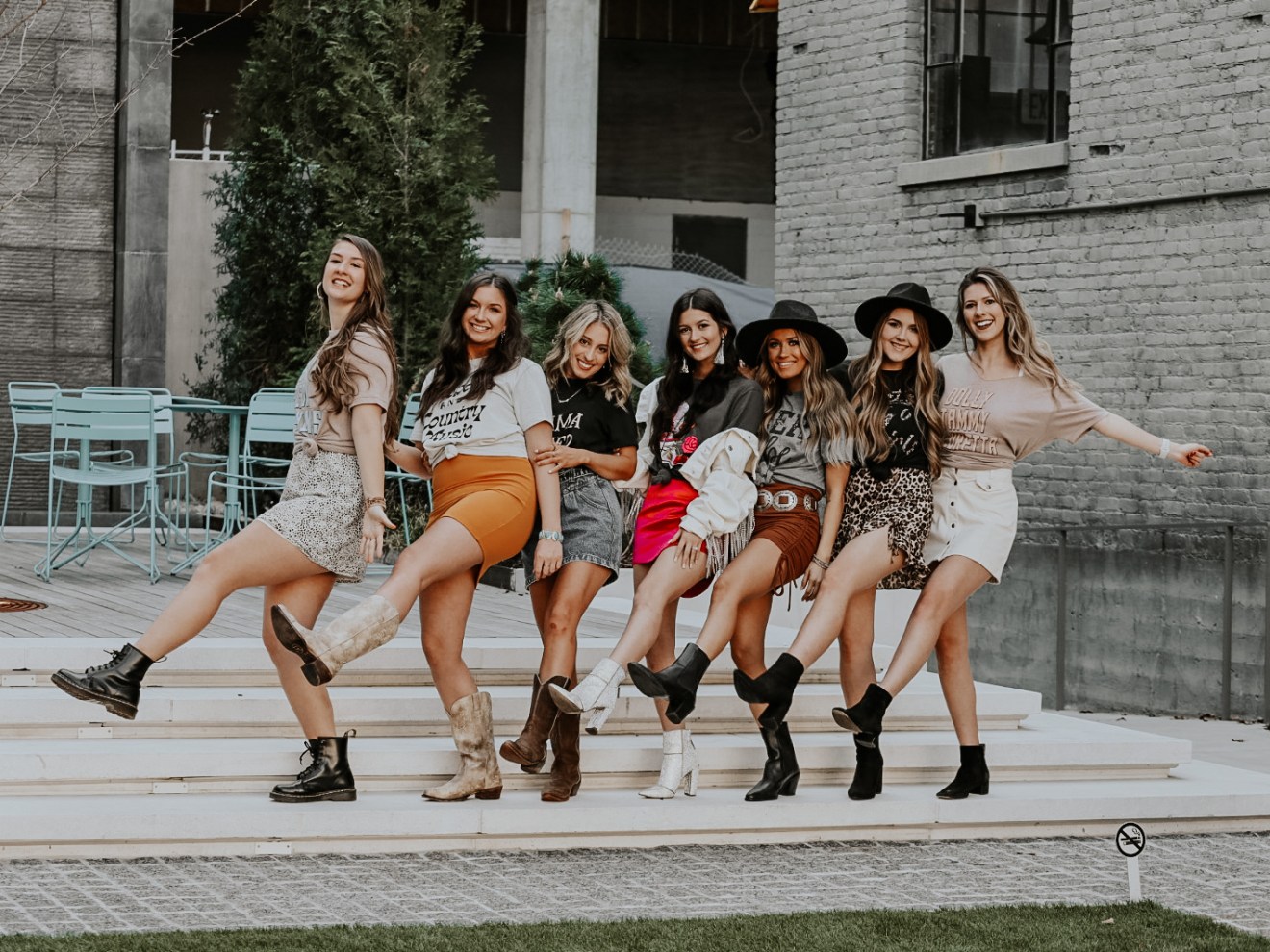 a group of people sitting on a bench in front of a building