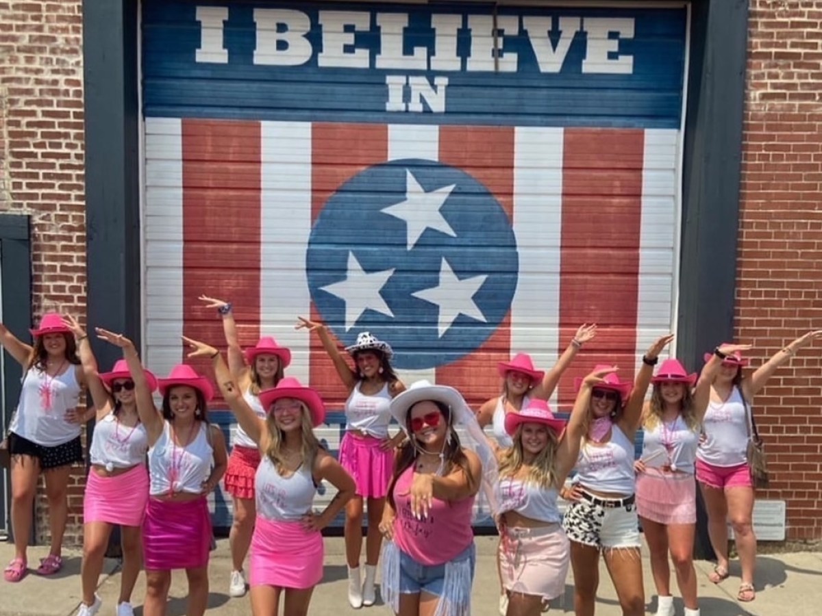 a group of people standing in front of a brick building