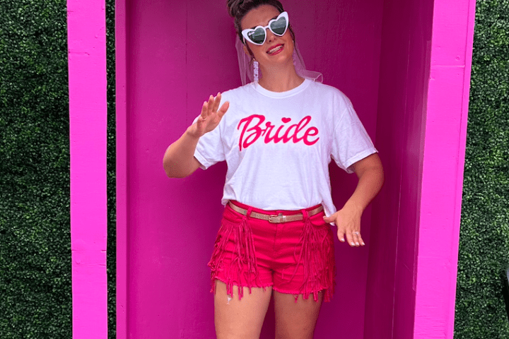 a person standing in front of a sign posing for the camera