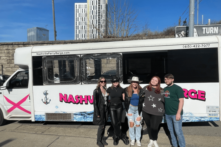 a group of people standing in front of a bus