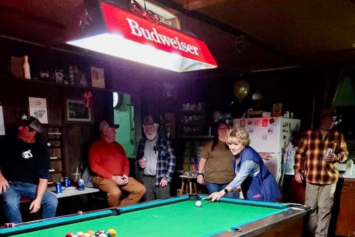 a group of people sitting at a table with a ball in a room